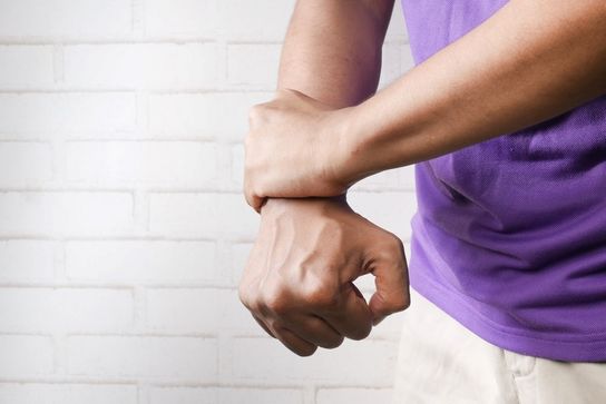 two hands, one holding the wrist of the other